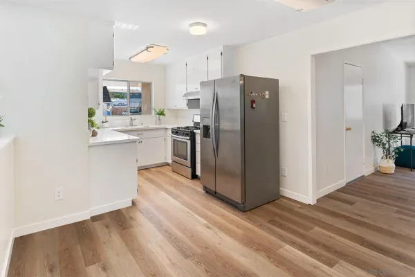 a kitchen with stainless steel appliances a refrigerator and a stove