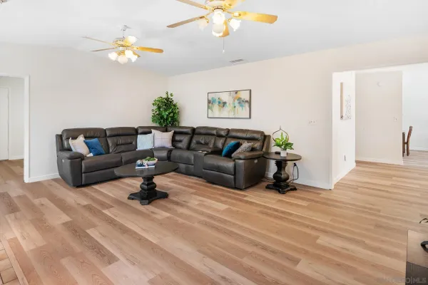 a living room with furniture and a chandelier