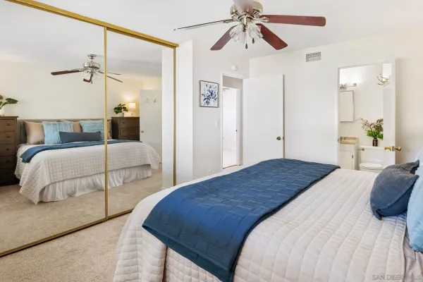 a bedroom with a bed and a mirror