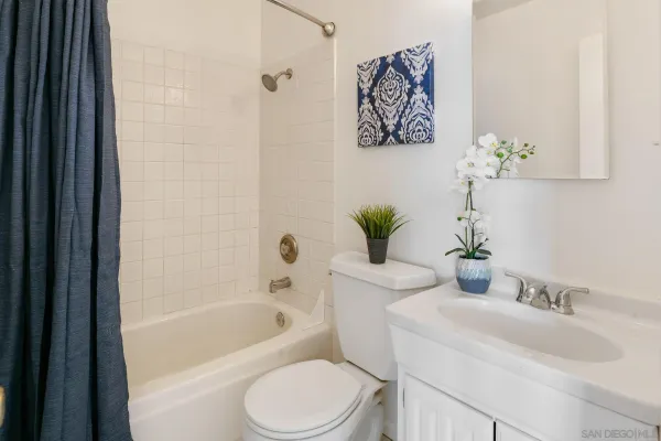 a bathroom with a sink a toilet and bathtub