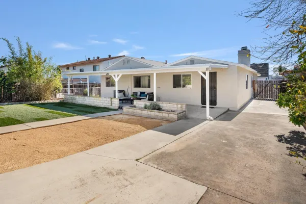 a front view of a house with yard patio and green space