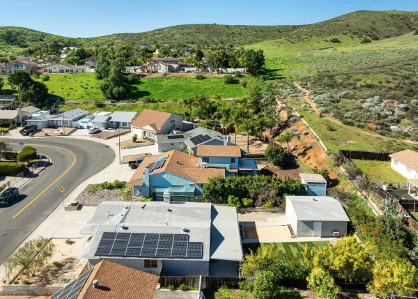 an aerial view of residential houses with outdoor space