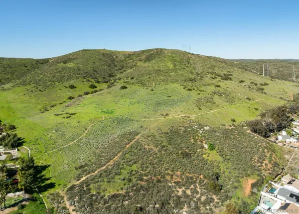 a view of a mountain range with lush green forest