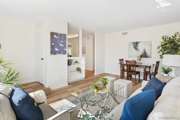 a living room with furniture and wooden floor