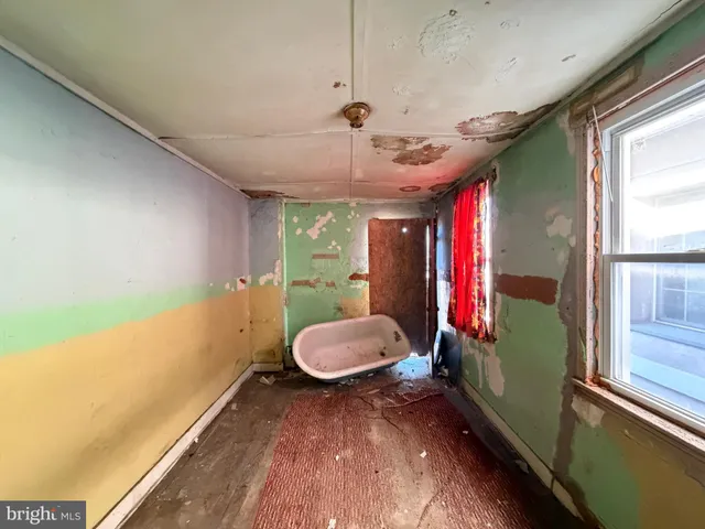 a view of a room with furniture and a window