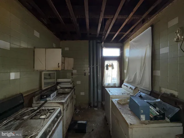 a kitchen with refrigerator and stove