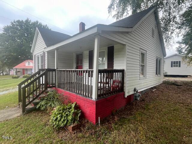 340 Cavel Chub Lake Road Roxboro, NC 27574 - Photo 4 of 12 a view of a house with wooden deck and a yard