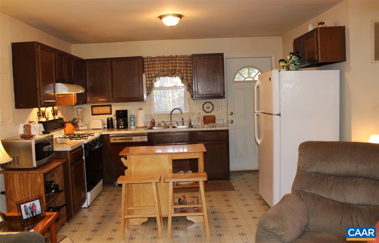 4143 Orange Road Aroda, VA 22709 - Photo 5 of 16 a kitchen with stainless steel appliances granite countertop a refrigerator a sink dishwasher a stove with wooden cabinets and floor