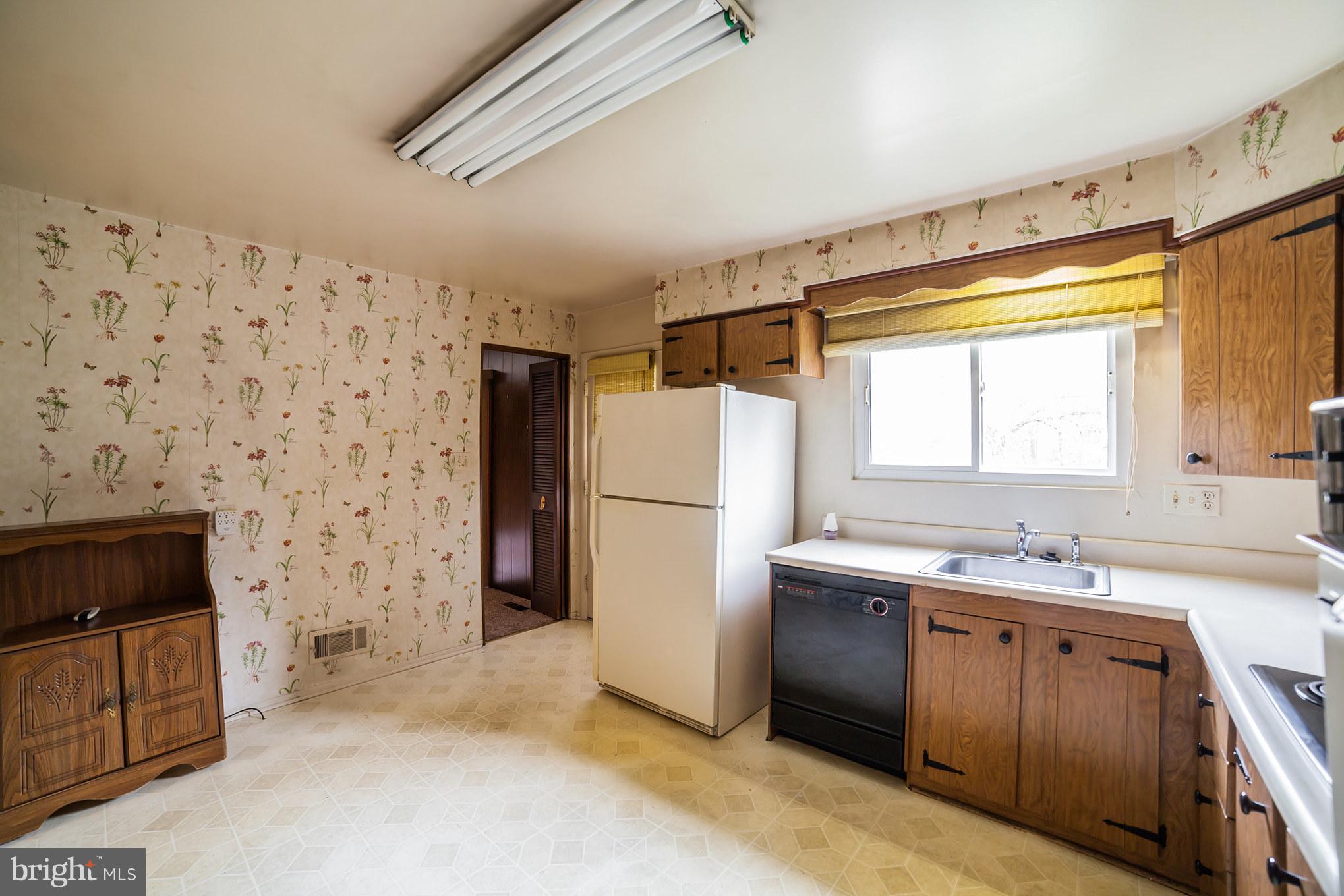 3903 Carthage Road Randallstown, MD 21133 - Photo 11 of 24 a kitchen with a sink stove and refrigerator