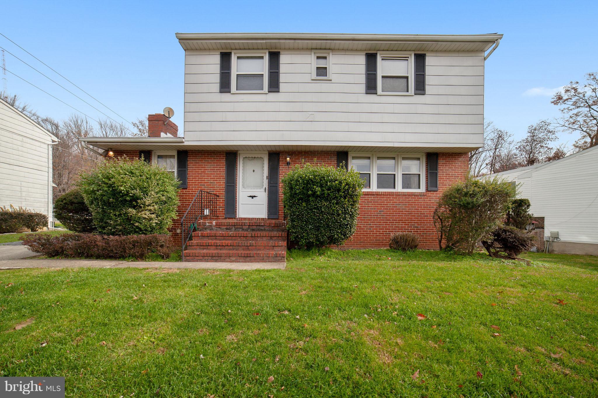 3903 Carthage Road Randallstown, MD 21133 - Photo 3 of 24 a front view of a house with a yard and garage