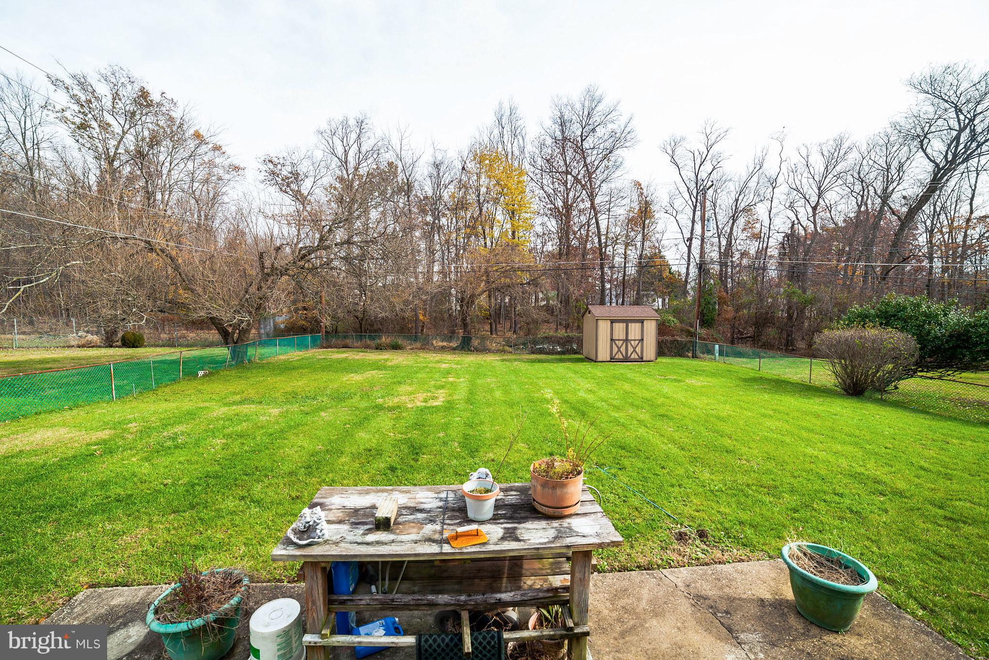 3903 Carthage Road Randallstown, MD 21133 - Photo 5 of 24 a view of a backyard with table and chairs potted plants and large tree