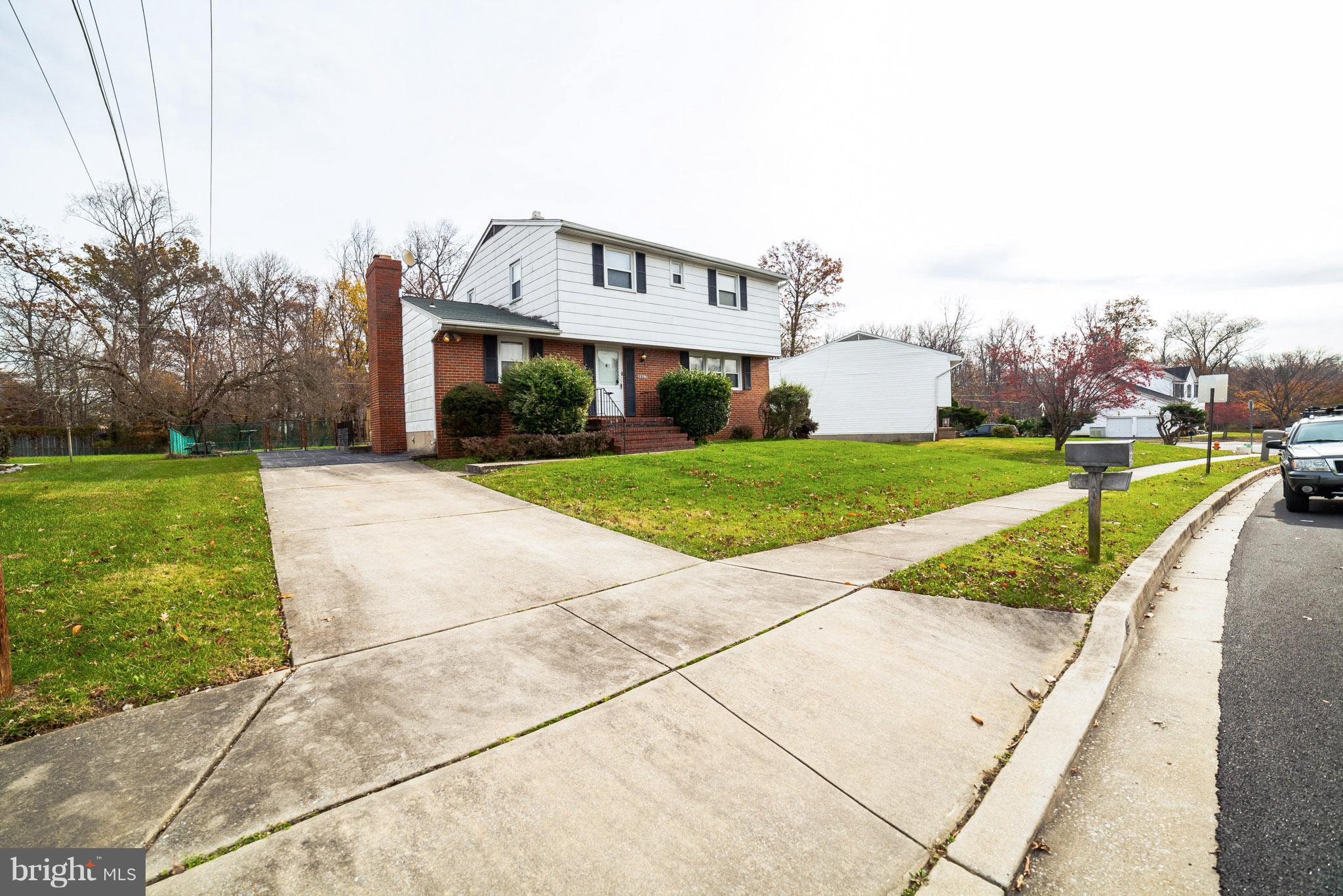 3903 Carthage Road Randallstown, MD 21133 - Photo 7 of 24 a view of a white house with a big yard and large trees