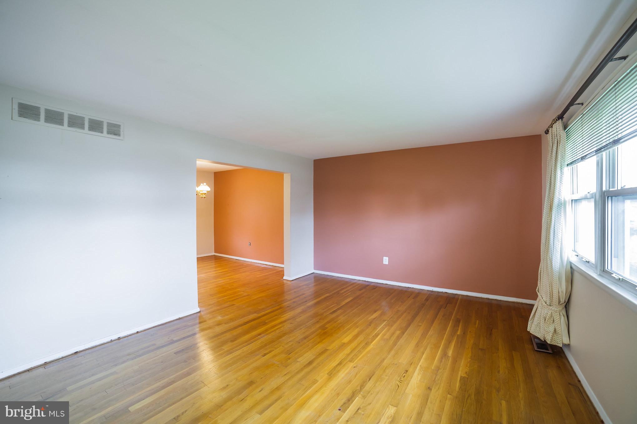 3903 Carthage Road Randallstown, MD 21133 - Photo 8 of 24 a view of an empty room with wooden floor and a window