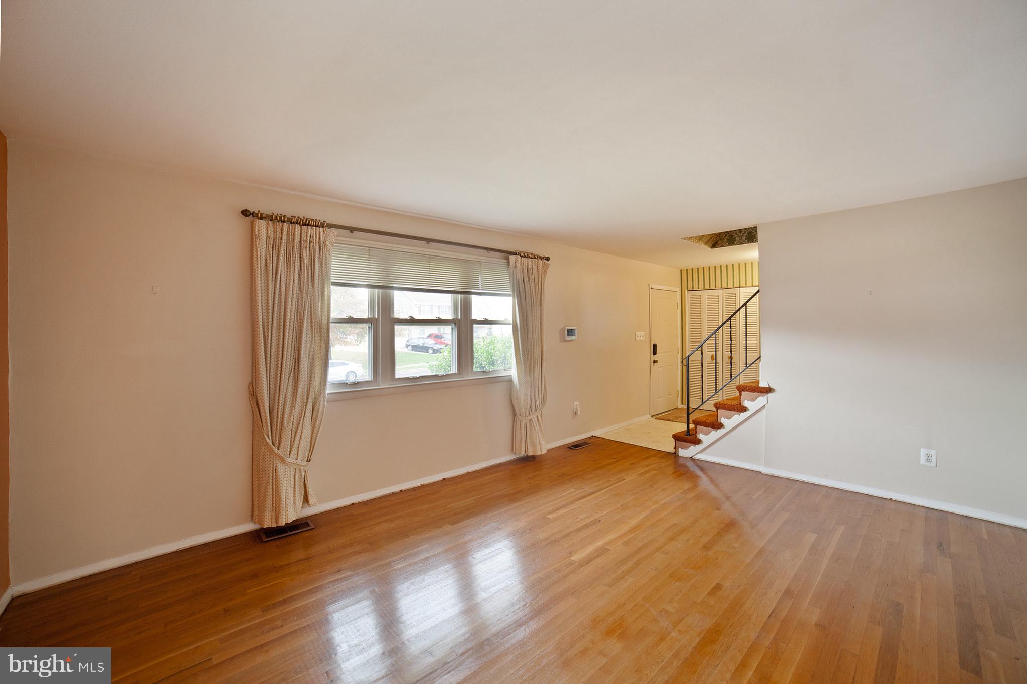 3903 Carthage Road Randallstown, MD 21133 - Photo 9 of 24 an empty room with wooden floor and windows
