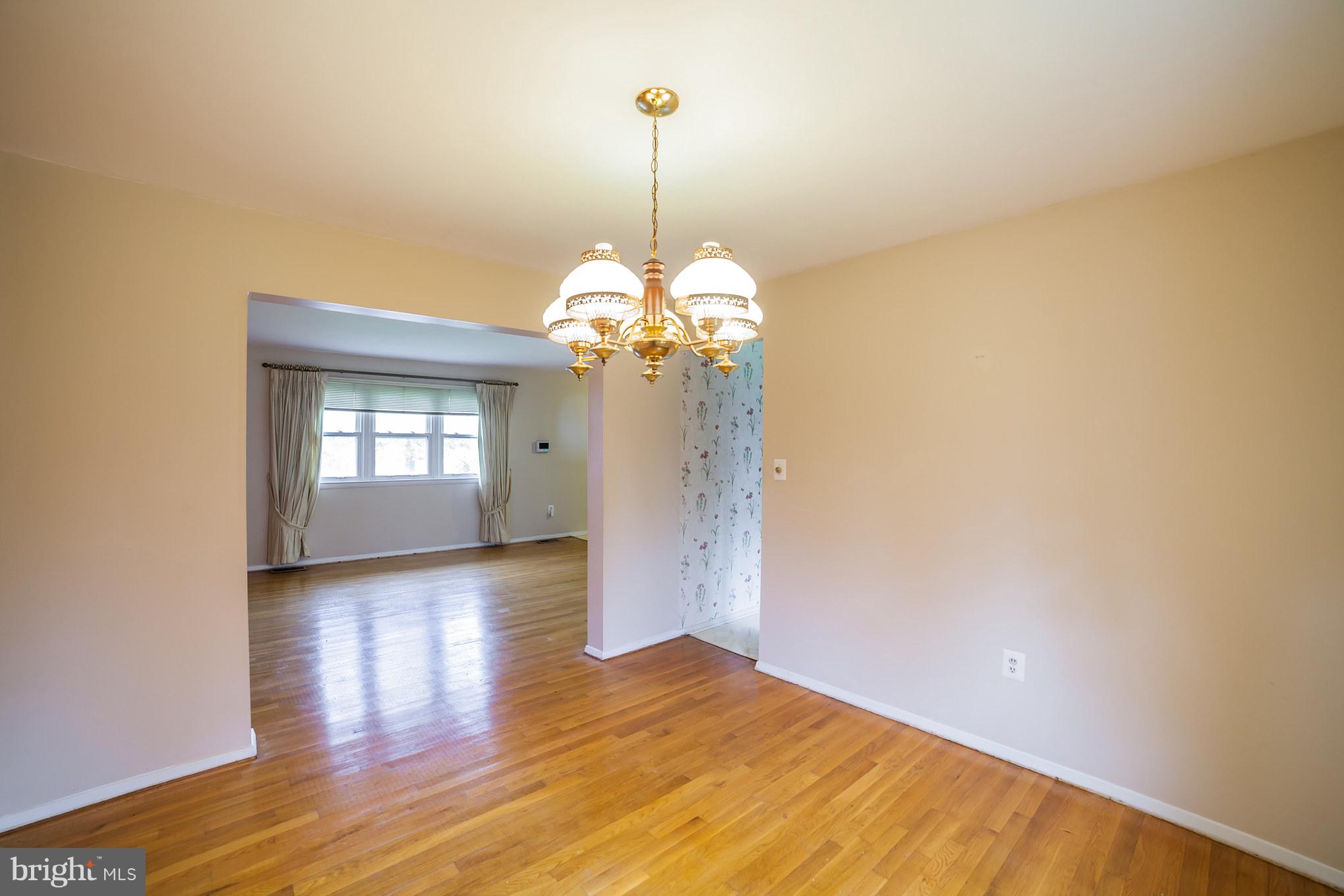 3903 Carthage Road Randallstown, MD 21133 - Photo 10 of 24 a view of a room with a chandelier fan and wooden floor
