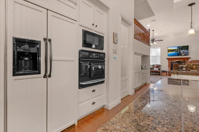 a living room with furniture a chandelier and a bookshelf