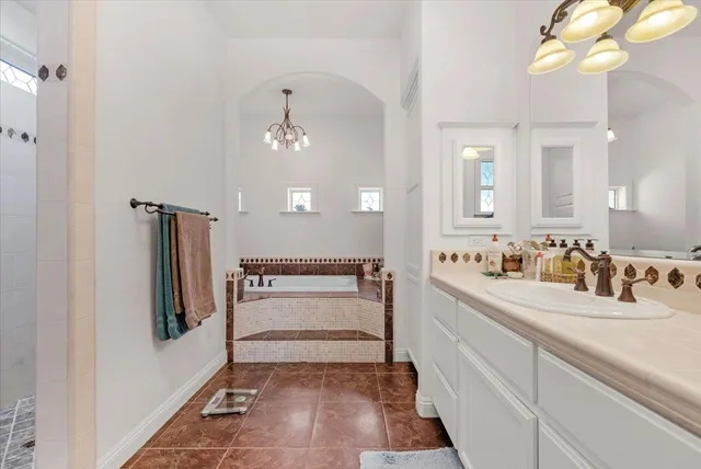 an aerial view of a house with a yard swimming pool a patio and lake view