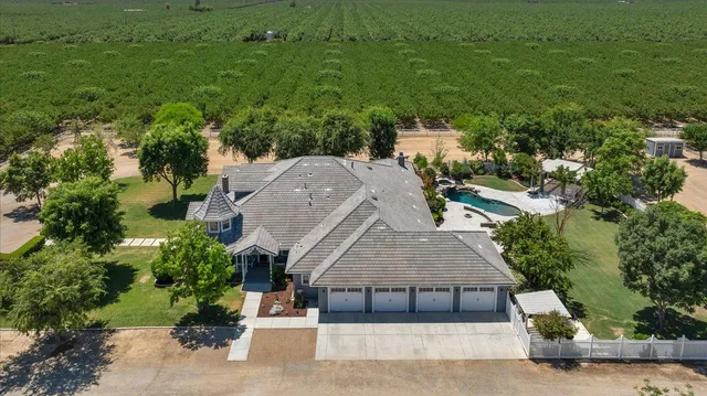 an aerial view of a houses with a yard