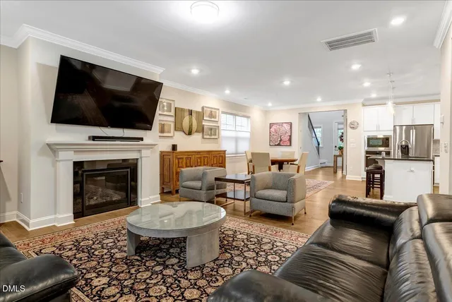 a room with furniture pool table flat screen tv and windows