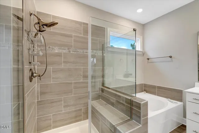 a bedroom with a bed a potted plant a dresser and a window