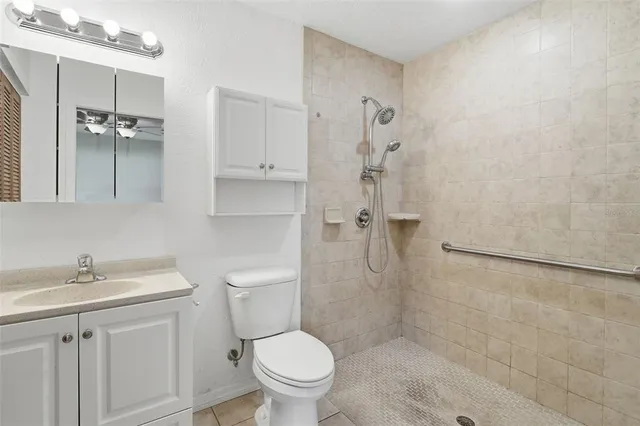 a bathroom with a toilet sink and shower
