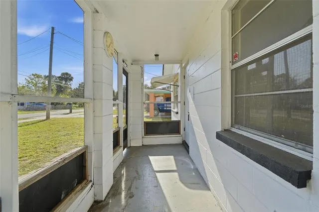 a kitchen with granite countertop white cabinets and window