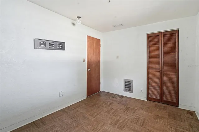 an empty room with fan and windows