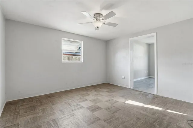 an empty room with windows and closet