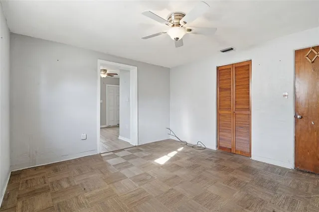 a bedroom with a bed and a potted plant