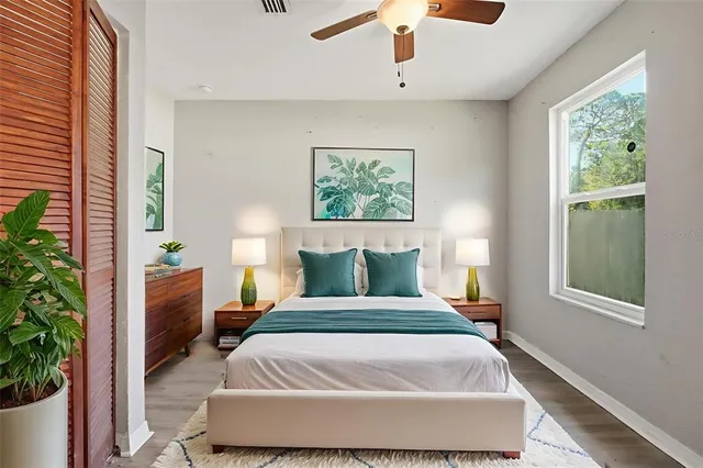 a living room with furniture a ceiling fan and a window