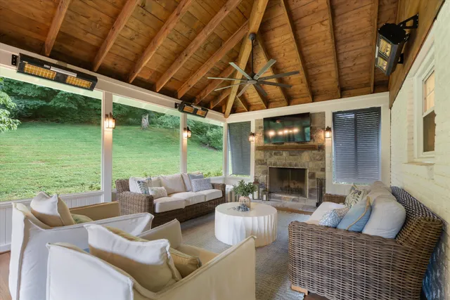 a outdoor living space with patio furniture and a fireplace