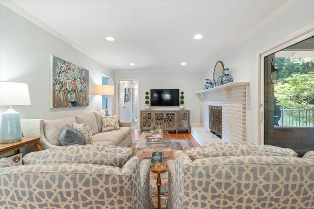 a living room with furniture a fireplace and a flat screen tv