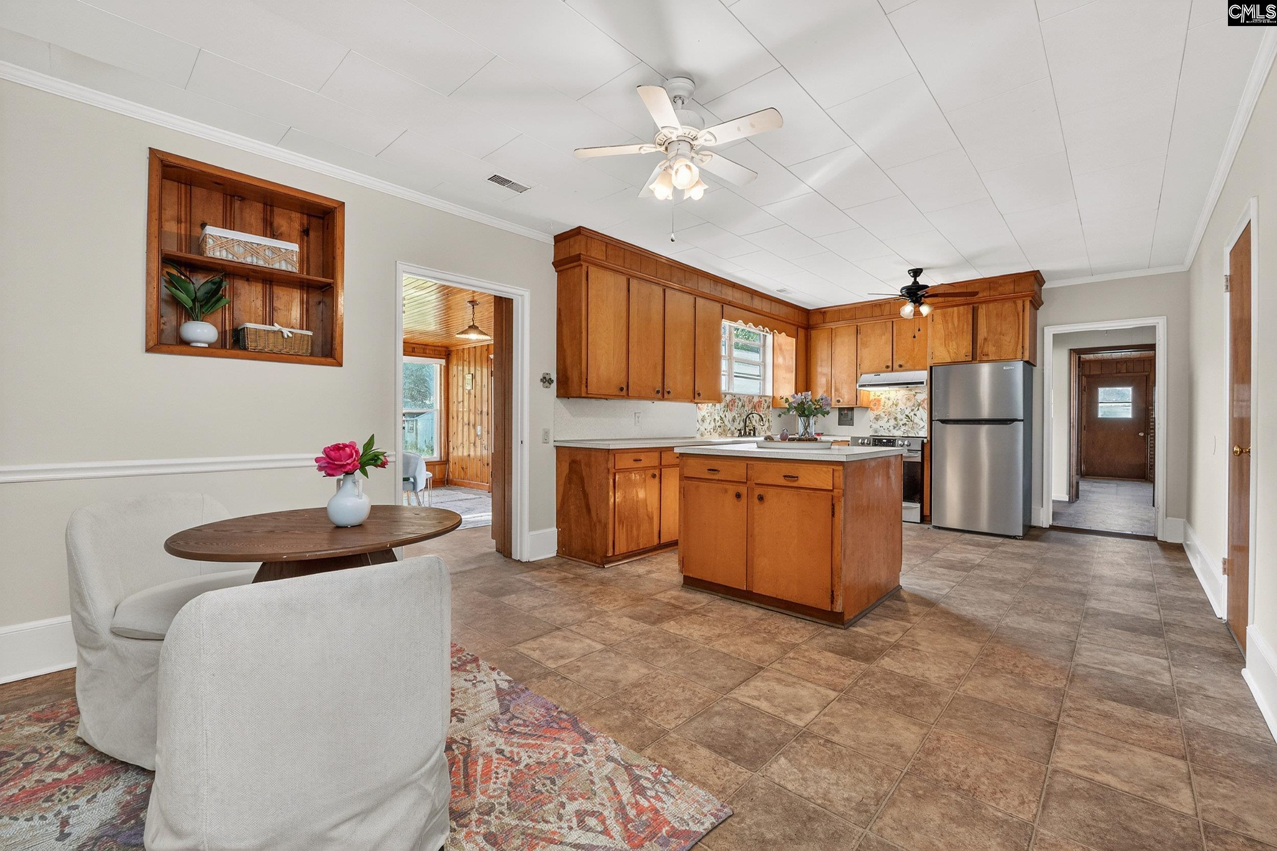 729 Magnolia Street Pelion, SC 29123 - Photo 9 of 32 a living room with stainless steel appliances kitchen island granite countertop furniture and a kitchen view