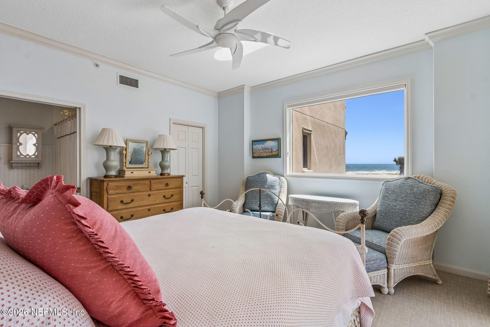 404 Beachside Place Fernandina Beach, FL 32034 - Photo 22 of 96 a bedroom with a bed and a chandelier