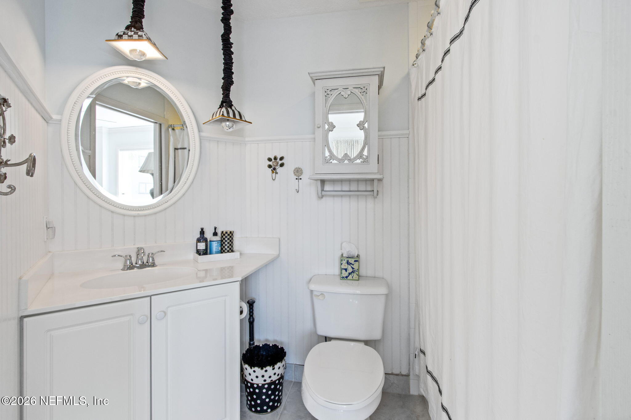 404 Beachside Place Fernandina Beach, FL 32034 - Photo 23 of 96 a bathroom with a toilet a sink and mirror