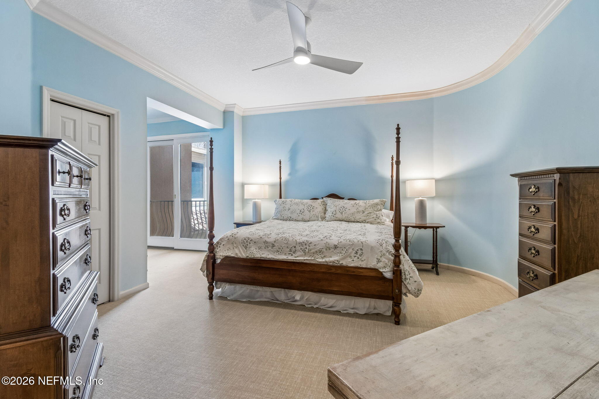 404 Beachside Place Fernandina Beach, FL 32034 - Photo 24 of 96 a bedroom with a large bed and a chandelier