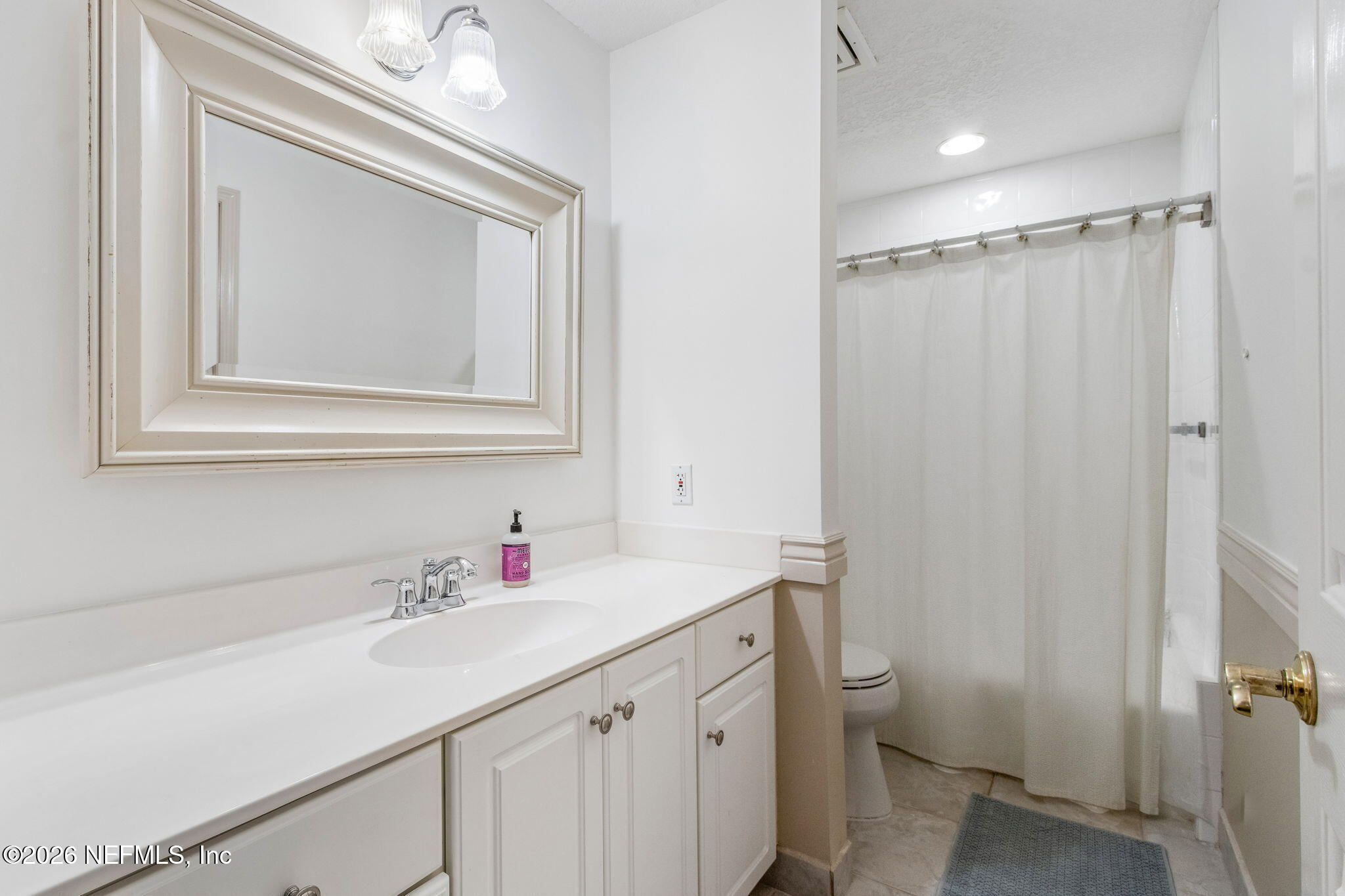 404 Beachside Place Fernandina Beach, FL 32034 - Photo 27 of 96 a bathroom with a sink vanity mirror and toilet