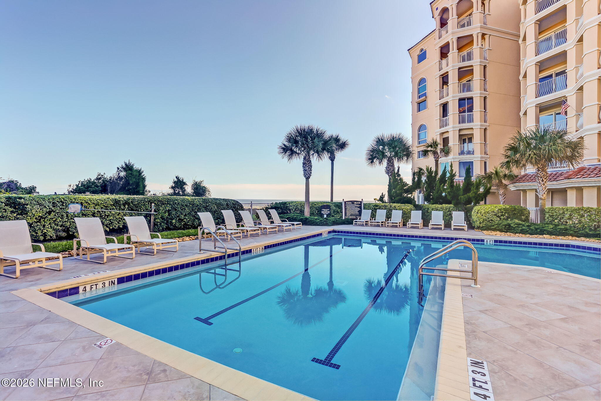 404 Beachside Place Fernandina Beach, FL 32034 - Photo 35 of 96 a view of a swimming pool with a table and chairs