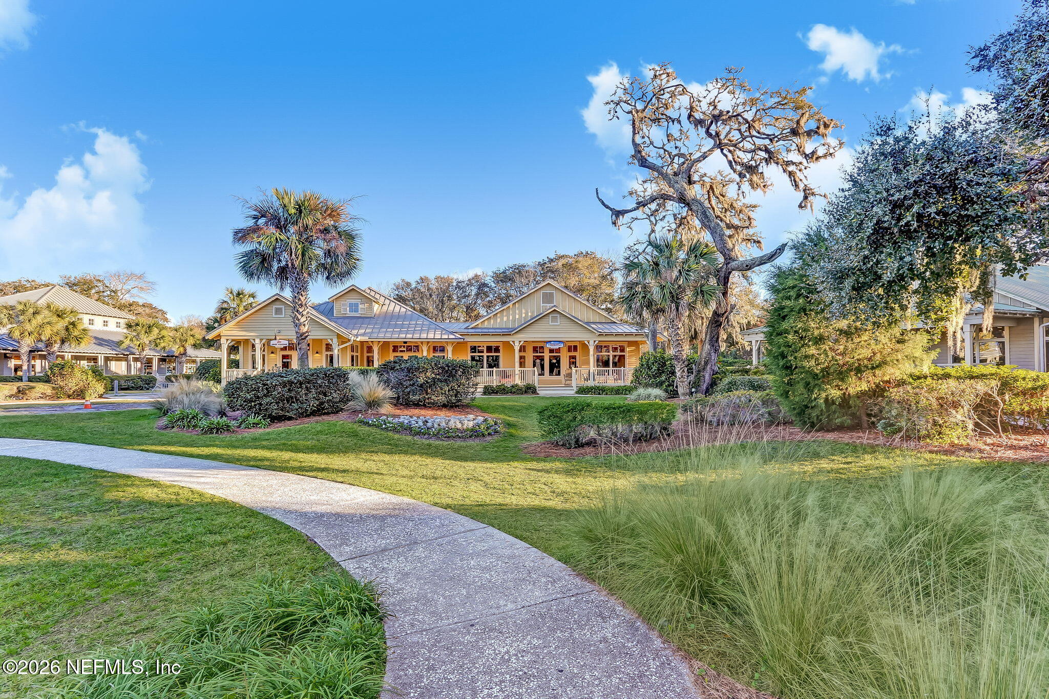 404 Beachside Place Fernandina Beach, FL 32034 - Photo 47 of 96 a front view of a house with a big yard and potted plants