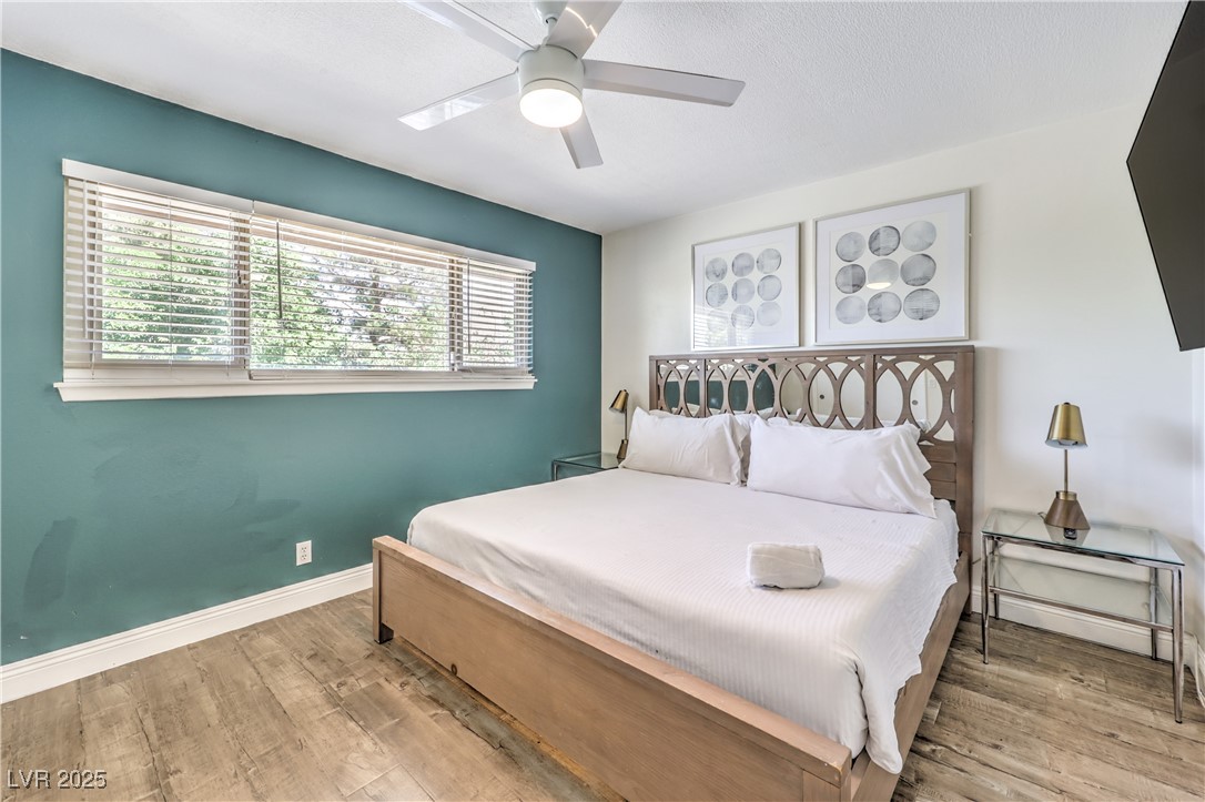 1553 Dorothy Avenue, Unit 4 Las Vegas, NV 89119 - Photo 13 of 36 Bedroom with light wood-style floors and ceiling fan