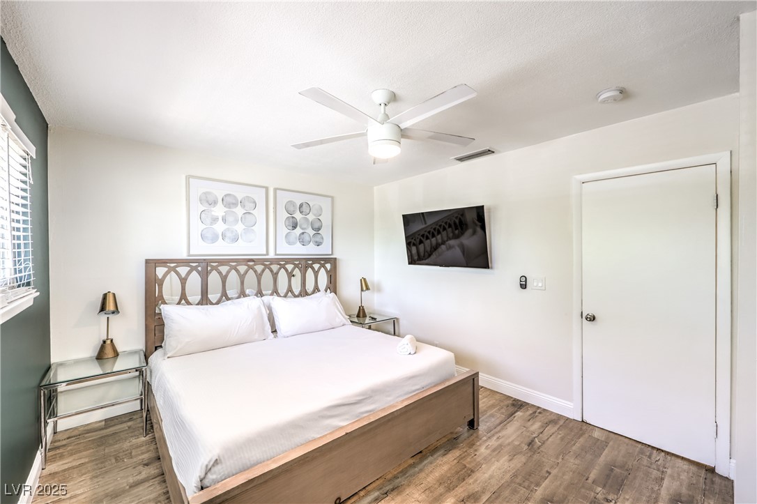 1553 Dorothy Avenue, Unit 4 Las Vegas, NV 89119 - Photo 14 of 36 Bedroom with wood finished floors and ceiling fan