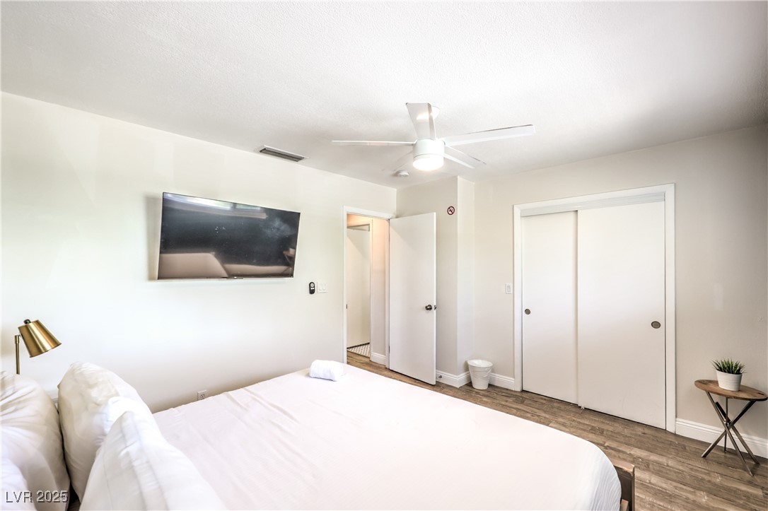 1553 Dorothy Avenue, Unit 4 Las Vegas, NV 89119 - Photo 15 of 36 Bedroom featuring wood finished floors, a ceiling fan, and a closet