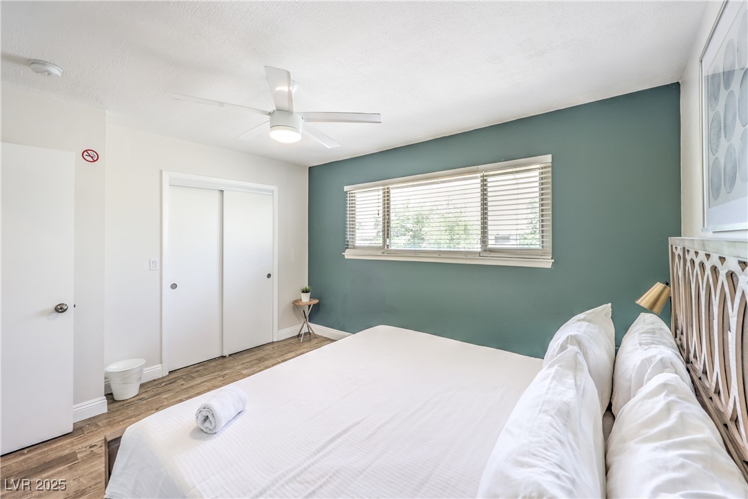 1553 Dorothy Avenue, Unit 4 Las Vegas, NV 89119 - Photo 16 of 36 Bedroom featuring wood finished floors, a ceiling fan, and a closet