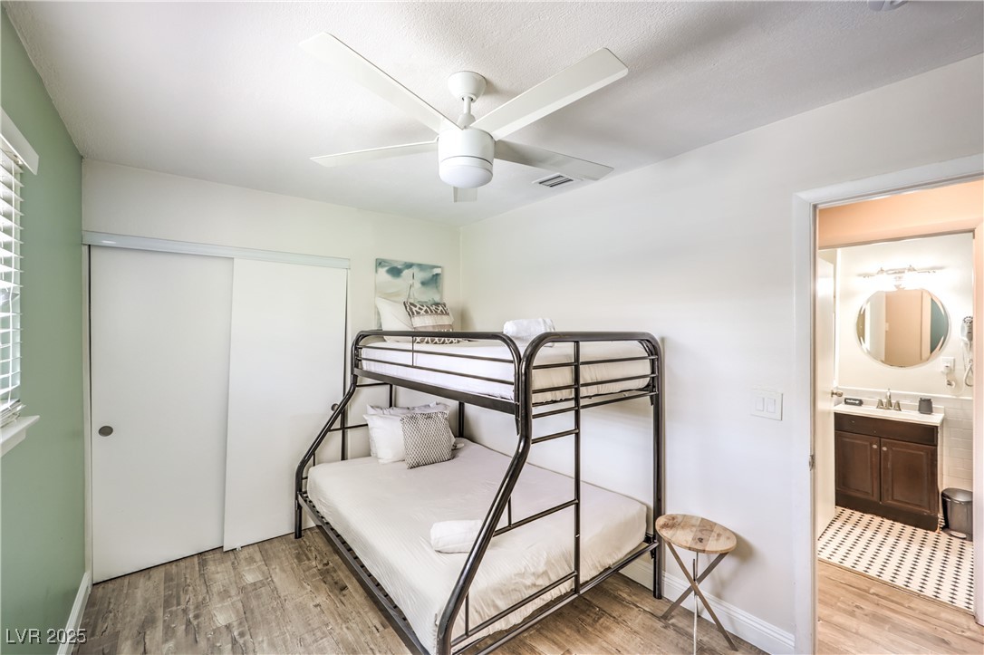 1553 Dorothy Avenue, Unit 4 Las Vegas, NV 89119 - Photo 18 of 36 Bedroom featuring light wood finished floors, a ceiling fan, and a closet