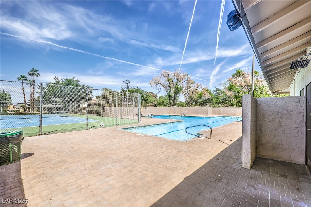1553 Dorothy Avenue, Unit 4 Las Vegas, NV 89119 - Photo 23 of 36 Community pool featuring a patio and a tennis court