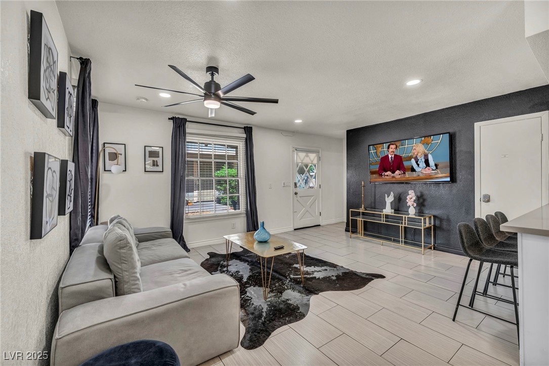1553 Dorothy Avenue, Unit 4 Las Vegas, NV 89119 - Photo 34 of 36 Living area featuring a ceiling fan, wood tiled floors, recessed lighting, and a textured ceiling