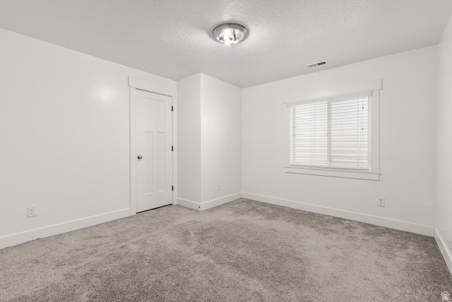 463 South Trejo Ridge Road Grantsville, UT 84029 - Photo 11 of 22 Carpeted room featuring a window with blinds, a three-panel interior door, white baseboards, and a semi-flush ceiling light fixture