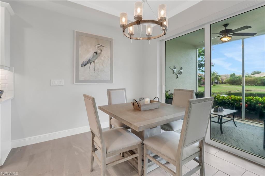 2295 Sawyers Hill Road, Unit 1002 Naples, FL 34120 - Photo 11 of 41 a view of a dining room with furniture window and outside view