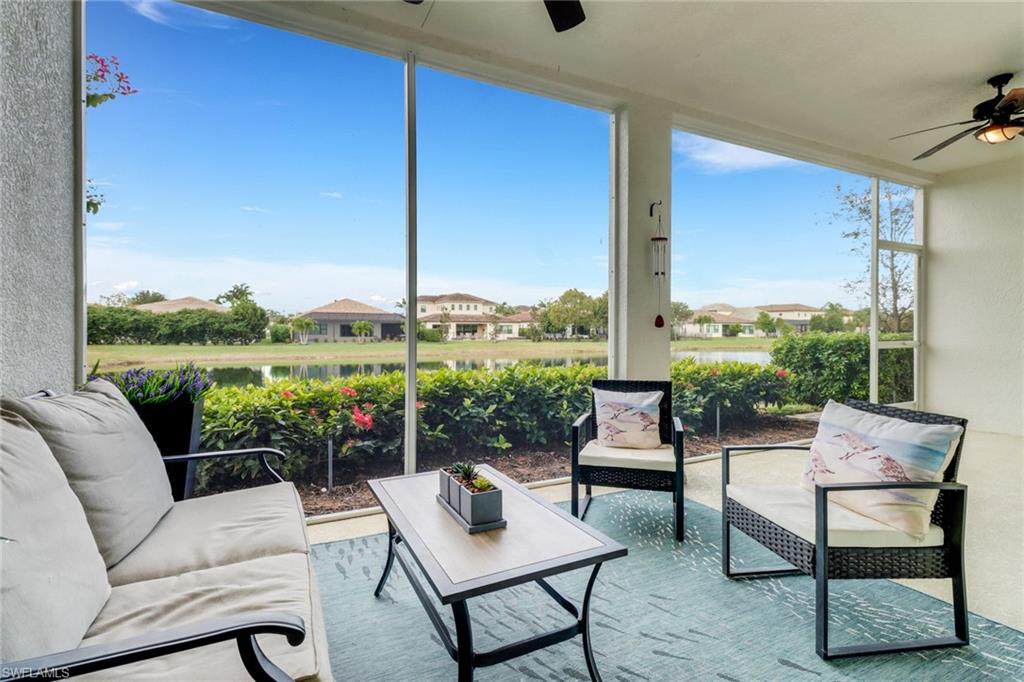 2295 Sawyers Hill Road, Unit 1002 Naples, FL 34120 - Photo 12 of 41 a living room with furniture city view and a floor to ceiling window