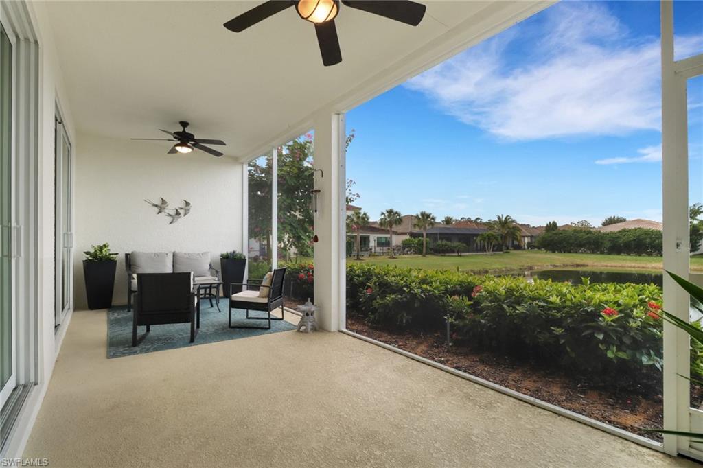 2295 Sawyers Hill Road, Unit 1002 Naples, FL 34120 - Photo 13 of 41 a view of a terrace with furniture and a floor to ceiling window